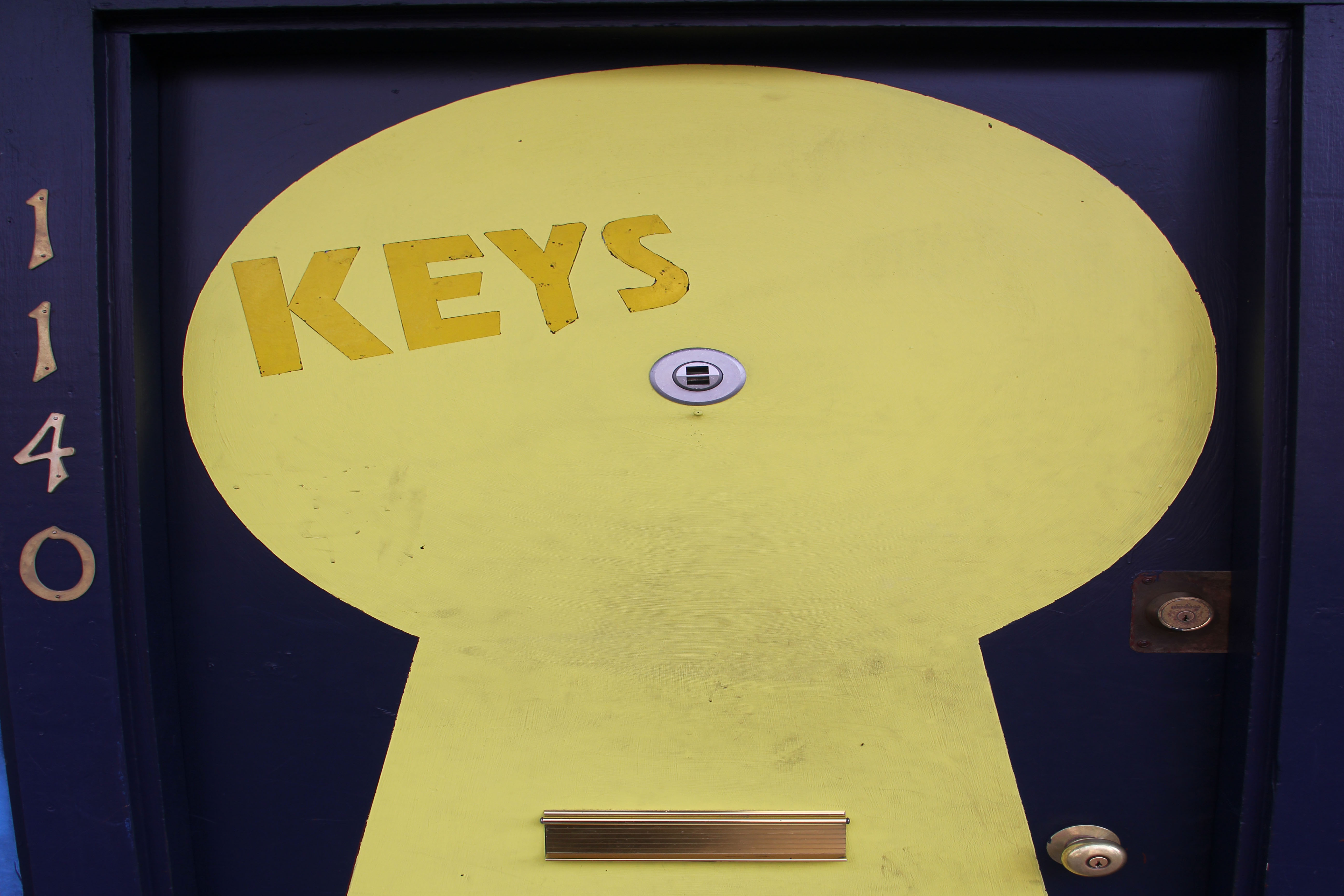 Photo of The word KEYS and a keyhole on the front door of 1140 University Avenue Berkeley CA